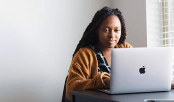 woman sitting in front of a laptop