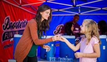 Mom and daughter enjoy some water after a Boosterthon Fun Run.