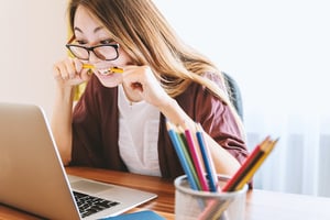 stressed  woman biting on pencil