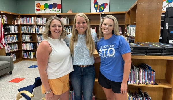 Image of PTO women in the school library smiling