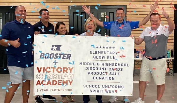 Image of school staff celebrating with Booster members 