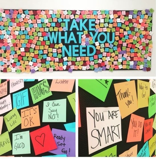A wall of post-it notes saying cheerful messages.