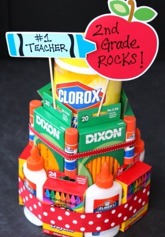 A school supply “cake” composed of classroom supplies like glue, crayons, and pencils.