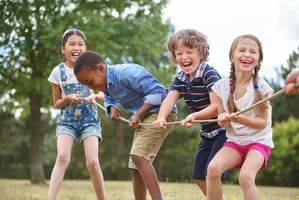 kids playing tug a war outside 