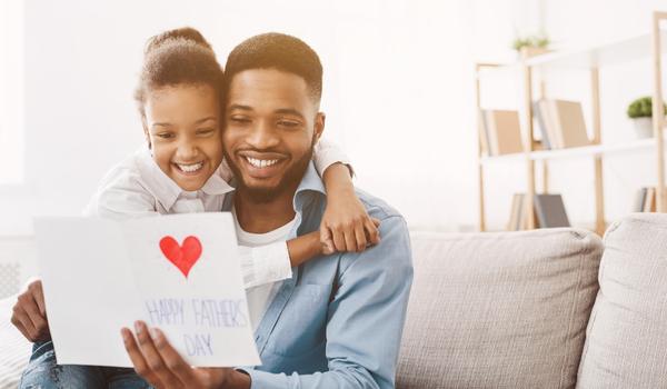 Father and daughter reading a card