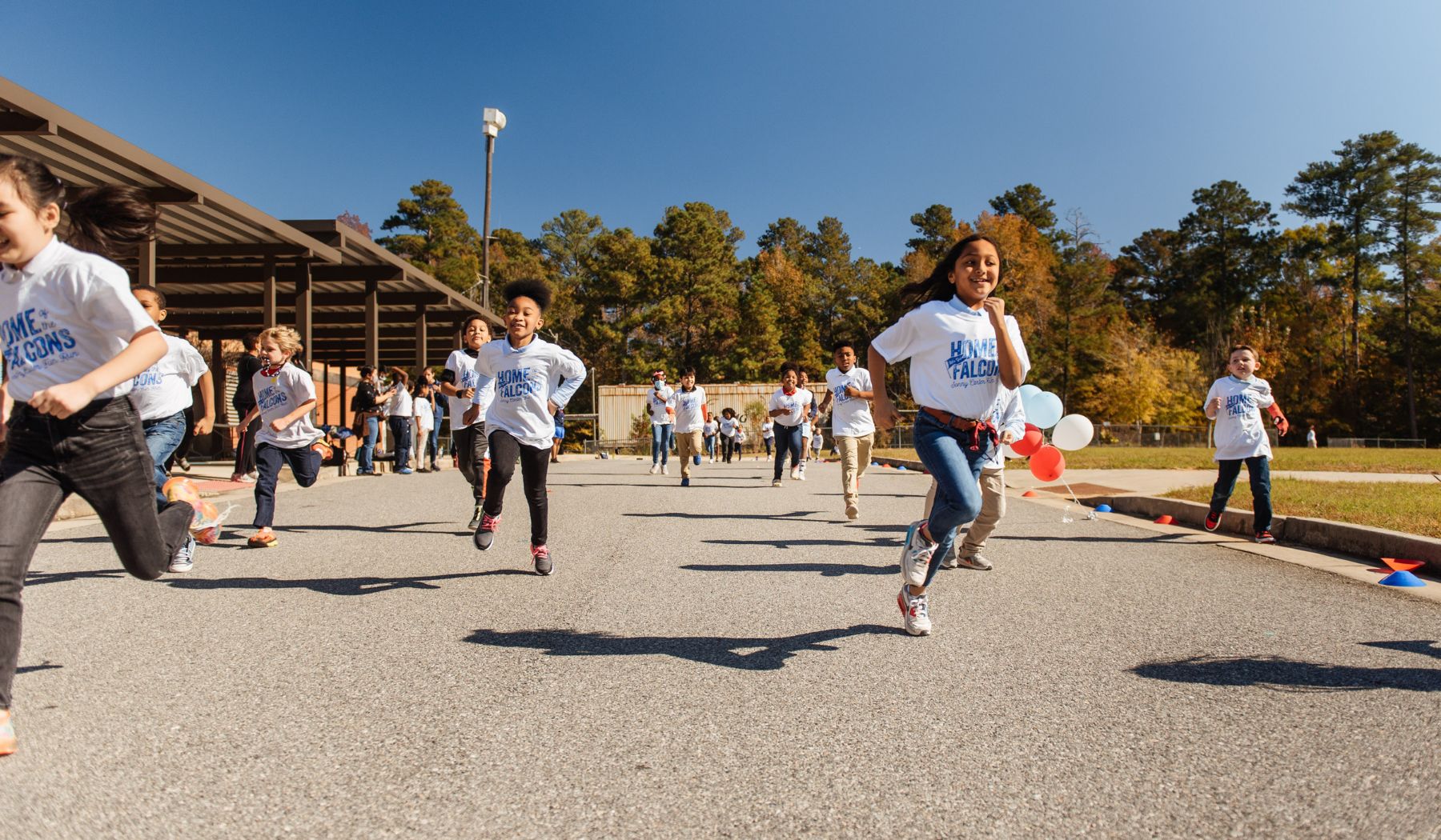 Children running outside during a Booster Fun Run