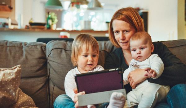 woman on couch with two children