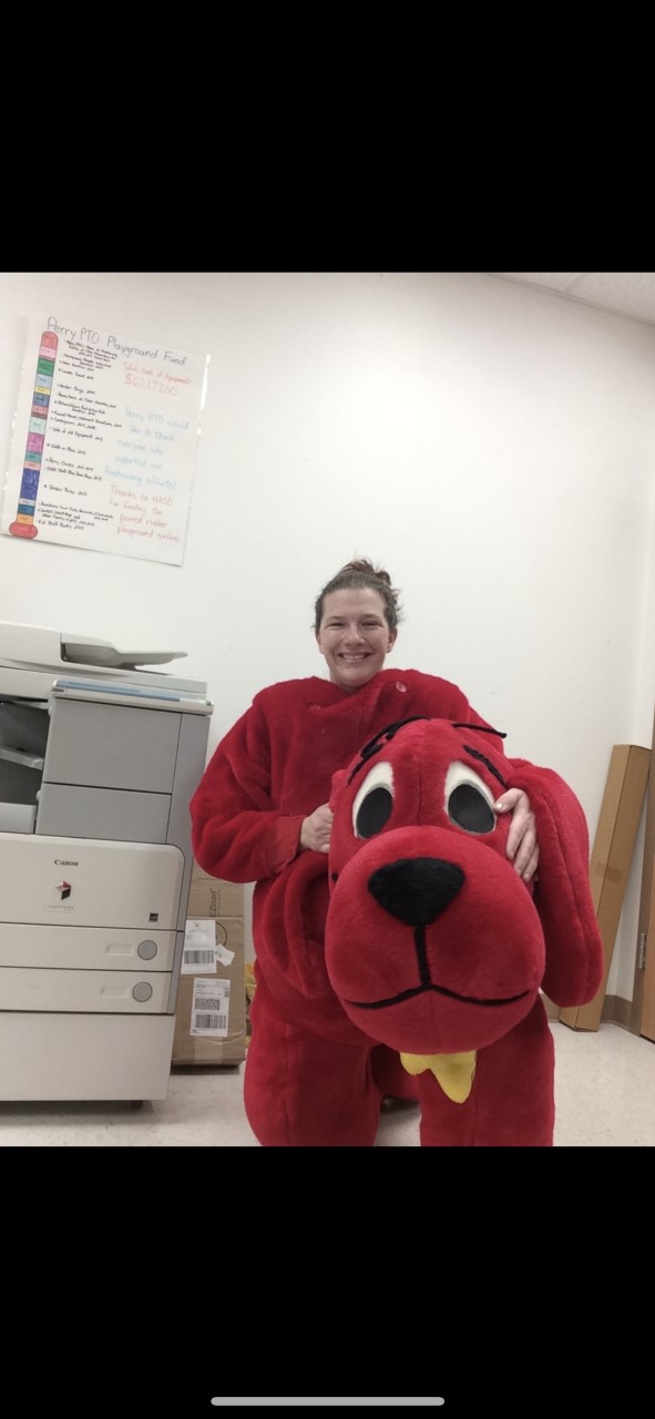 Lady in a big red Clifford costume at a school