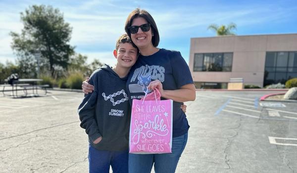 Mother and son outside celebrating winning Booster's October Volly Award