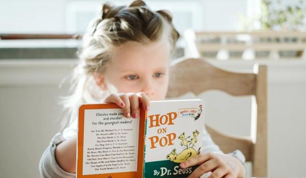 Girl reading a book at a table