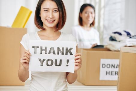 women holding thank you sign